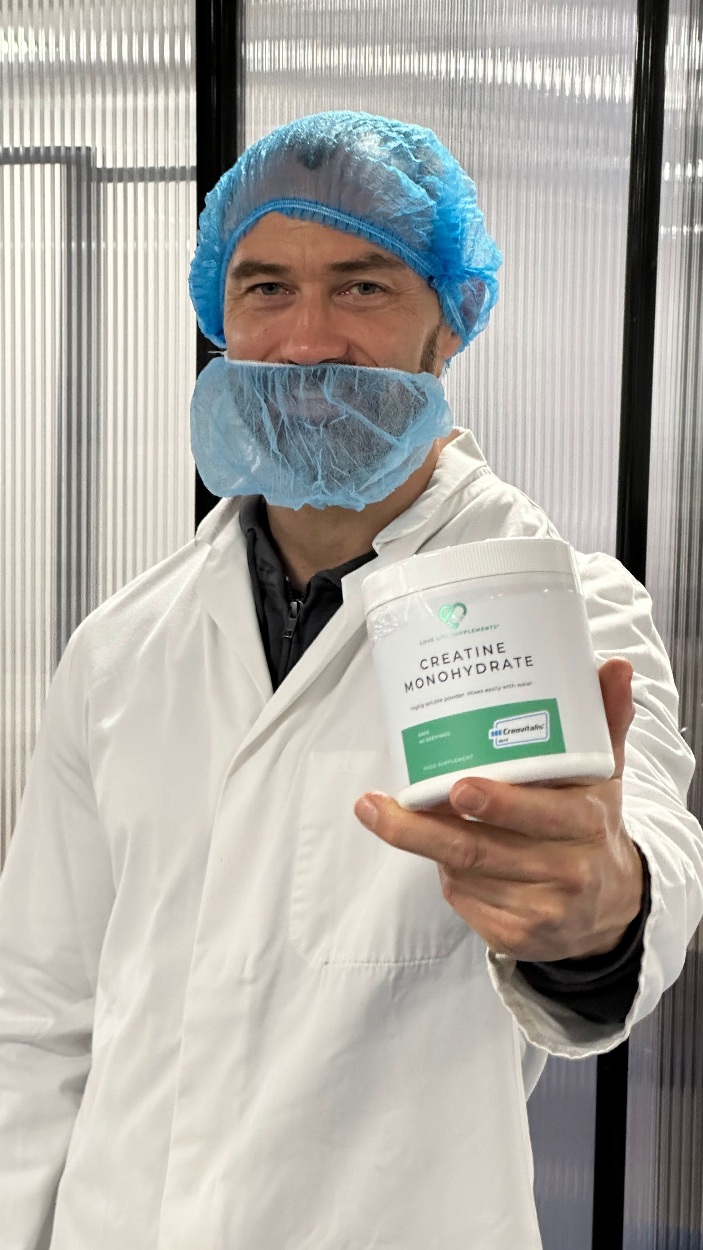 ben law Person in a lab setting holding a container labeled &