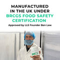 Person in a cleanroom holding a container with text about BRCGS food safety certification.