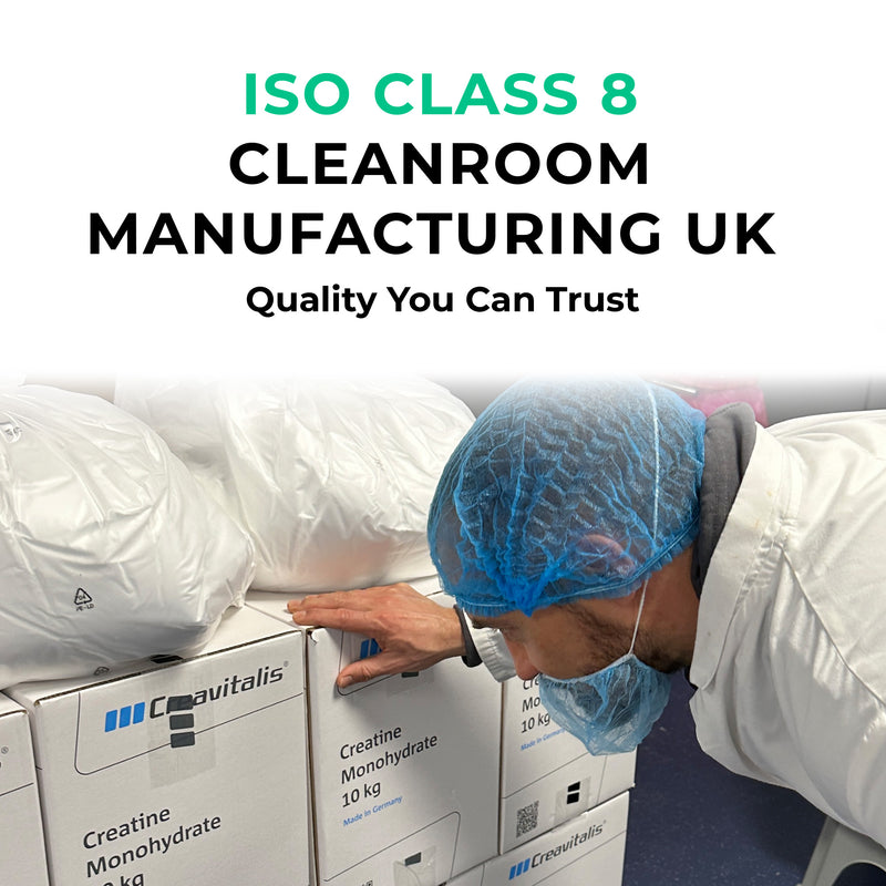 Person in a cleanroom environment with Creavitalis boxes, wearing a hairnet and mask.