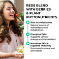 Reds powder  Woman eating a salad with text about the benefits of berries and plant phytonutrients.