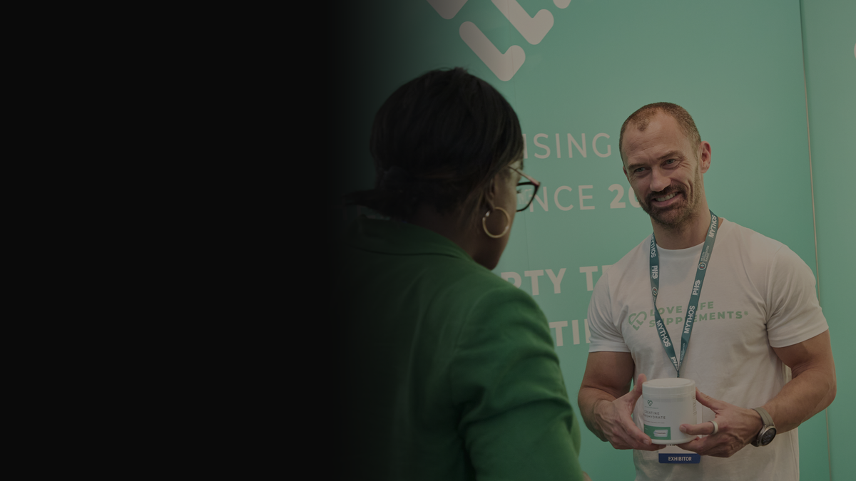 Ben Law, founder of Love Life Supplements, showing Creatine Monohydrate to a visitor at the LLS stand